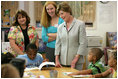 Mrs. Laura Bush meets and speaks with members of the Gorenflo Elementary School first grade class and their faculty Monday, Aug. 28, 2006, at their temporary portable classroom at the Beauvoir Elementary School in Biloxi, Miss. The students, whose school was damaged by Hurricane Katrina, are sharing the facilities of the Beauvoir school until their school's renovations are complete.