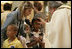 A young girl receives a blessing during a memorial Mass attended by President George W. Bush and Laura Bush at St. Louis Cathedral in New Orleans, Tuesday morning, Aug. 29, 2006, to commemorate the one- year anniversary of Hurricane Katrina.