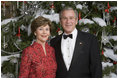 President George W. Bush and Mrs. Laura Bush pose for their official 2006 Holiday Portrait in the Blue Room of the White House. 
