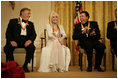 Conductor Zubin Mehta laughs with singers Dolly Parton and William "Smokey" Robinson during a reception for the Kennedy Center honorees in the East Room Sunday, Dec. 3, 2006.