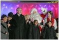 President George W. Bush and Laura Bush join entertainers Eartha Kitt, left, and Cathy Rigby, center, along with Santa Claus, invited children and The Singing Angels choir director Charles Eversole, right, on stage Thursday, Dec. 7, 2006, at the 2006 Christmas Pageant of Peace and the 83rd lighting of the National Christmas Tree on the Ellipse in Washington, D.C. 