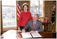 President George W. Bush is joined by Laura Bush, Wed. Feb. 1, 2006 in the Oval Office at the White House, as he signs a proclamation in honor of American Heart Month.