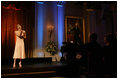 President George W. Bush and Laura Bush listen to country music artist LeAnn Rimes perform in the East Room of the White House during a dinner honoring The Dance Theatre of Harlem Monday, February 6, 2006.