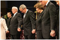 President George W. Bush and Mrs. Laura Bush are seen during a prayer holding hands with former President Bill Clinton, right, and Rev. Robert Schuller, left, at the homegoing celebration for Coretta Scott King, Tuesday, Feb. 7, 2006 at the New Birth Missionary Church in Atlanta, Ga.