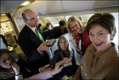 Laura Bush talks with members of the press aboard her plane en route to Turin, Italy, Friday, Feb. 10, 2006.