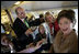 Laura Bush talks with members of the press aboard her plane en route to Turin, Italy, Friday, Feb. 10, 2006.