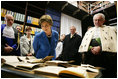 Laura Bush looks at books dating to the 1500’s during a tour of the Ancient Library at the University of Turin guided by Paolo Novaria, Archives, left, and Enrico Artifoni, right, Saturday, Feb. 11, 2006, in Turin, Italy.