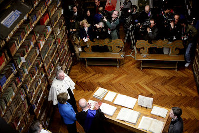 Laura Bush looks at an Ancient Thesis of Montichelli during a tour given by Enrico Artifoni, right, Paolo Novaria, right, and Andrea Carosso at the University of Turin Saturday, Feb. 11, 2006, in Turin, Italy.
