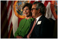 Laura Bush sits with Carlos del la Cruz, Event Host, during a Junior Ranger event Wednesday, Feb. 15, 2006, in Coral Gables, FL. The Junior Ranger programs introduces young people to America's national parks and historic sites, and is operating in 286 of the 388 National Parks across the country.