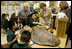 Laura Bush, listens to a student talk about Sea Turtles, Thursday, Feb. 16, 2006, as Fran Mainella, Director of the National Park Service, and Stella Summers, Teacher of the Gifted Science class, look on during a visit to Banyan Elementary School in Miami, FL, to support education about parks and the environment.