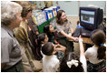 Laura Bush and Fran Mainella look on as students of Stella Summer’s Gifted Science class work with Ranger Maria Beotegui Thursday, Feb. 16, 2006, to navigate through Web Rangers, the online version of Junior Rangers, during a visit to Banyan Elementary School in Miami, FL. The National Junior Ranger Programs promote knowledge of science, history, the environment and learning through fun.