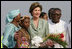 Mrs. Laura Bush stands with 10-year-old Aisha Garuba Sunday, Jan. 15, 2006, after she presented Mrs. Bush with flowers upon her arrival at Kotoka International Airport in Accra, Ghana.