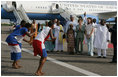 Mrs. Laura Bush and her daughter Barbara Bush are greeted by a cultural dance troupe upon their arrival Sunday, Jan. 15, 2006 at Kotoka International Airport in Accra, Ghana.