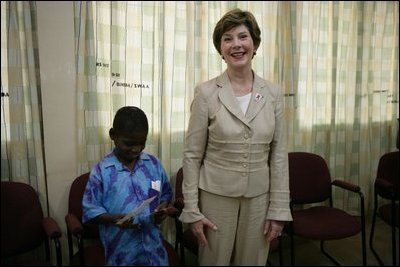 Mrs. Laura Bush stands with a young boy as she visits with patients, their family members and staff at the Korle-Bu Treatment Center, Tuesday, Jan. 17, 2006 in Accra, Ghana.