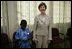 Mrs. Laura Bush stands with a young boy as she visits with patients, their family members and staff at the Korle-Bu Treatment Center, Tuesday, Jan. 17, 2006 in Accra, Ghana.