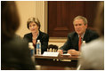 President George W. Bush and Mrs. Bush listen during meeting with heads of foundations to help aid Gulf Coast Recovery at the White House, Thursday, Jan. 19, 2006.