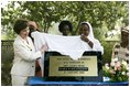 Mrs. Laura Bush helps unveil a plaque dedicating the Saint Kizito Complex at Saint-Mary's Catholic Church in Gwagwalada, Nigeria Wednesday, Jan. 18, 2006.