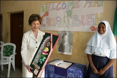Laura Bush admires a gift presented to her at the conclusion of her visit to the Model Secondary School in Abuja, Nigeria, January 18, 2006.