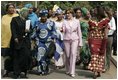 Laura Bush walks with members of the National Center for Women's Development in Abuja, Nigeria to the Women's Hall of Fame January 18, 2006.