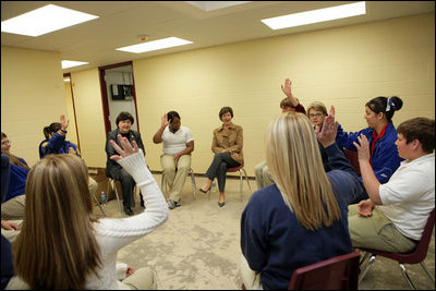 Laura Bush and U.S. Secretary of Education Margaret Spellings meet with staff and students Wednesday, Jan. 26, 2006 at the St. Bernard Unified School in Chalmette, La. Students raise their hands to acknowledge that their families lost everything in the storms of Hurricane Katrina.