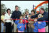 Laura Bush attends a ribbon cutting ceremony with football star Brett Favre and his wife, Deanna, left, Secretary Margaret Spelling, center, Dan Vogel, Associate Director, USA Fredom Corps, right, and student of Hancock North Central Elementary Shool at the Kaboom Playground, built at the Hancock North Central Elementary School in Kiln, Ms., Wednesday, Jan. 26, 2006, during a visit to the area ravaged by Hurricane Katrina.