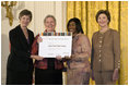 Laura Bush along with Mary Chute, Acting Director, Institute of Museums and Library Services, left, presents the 2005 National Awards for Museum and Library Services awards to St Paul Public Library Director, Kathleen Flynn, and Community Representative, Regina Harris, during a ceremony at the White House January 30, 2006. The Institute of Museum and Library Services’ National Awards for Museum and Library Service honor outstanding museums and libraries that demonstrate an ongoing institutional commitment to public service. It is the nation’s highest honor for excellence in public service provided by these institutions.