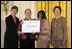 Laura Bush along with Mary Chute, Acting Director, Institute of Museums and Library Services, left, presents the 2005 National Awards for Museum and Library Services awards to St Paul Public Library Director, Kathleen Flynn, and Community Representative, Regina Harris, during a ceremony at the White House January 30, 2006. The Institute of Museum and Library Services’ National Awards for Museum and Library Service honor outstanding museums and libraries that demonstrate an ongoing institutional commitment to public service. It is the nation’s highest honor for excellence in public service provided by these institutions.