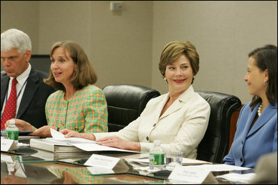 Mrs. Laura Bush smiles at Dina Hibab Powell, Deputy Under Secretary for Public Diplomacy, Public Affairs and Assistant Secretary of State for Educational and Cultural Affairs during the fifth meeting of the U.S. Afghan Women's Council at the State Department, Wednesday, July 5, 2006, in Washington, D.C. Also shown are Dr. Paula Dobrianksy, Under Secretary of State for Democracy and Global Affairs, left, and James Kunder, Assistant Administrator for Asia and the Near East, USAID.