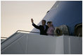 President George W. Bush and Mrs. Laura Bush wave upon arrival of Air Force One to Rostock-Laage Airport in Rostock, Germany on July 12, 2006. The couple is visiting with Germany's Chancellor Angela Merkel before proceeding to Russia for the G8 Summit.