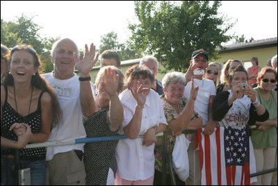 The President greets local residents. Well-wishers line the streets of Trinwillershagen, Germany, Thursday, July 13, 2006, awaiting a glimpse of President George W. Bush and Laura Bush as they arrive for a barbeque with German Chancellor Angela Merkel.
