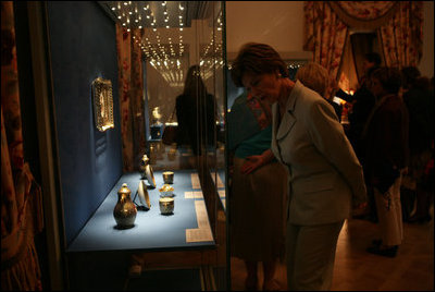 Laura Bush looks over a display piece Monday, July 17, 2006, at a Hermitage Exhibit for G8 spouses at the Konstantinovsky Palace Complex in Strelna, Russia, site of the 2006 G8 Summit that ended Monday.