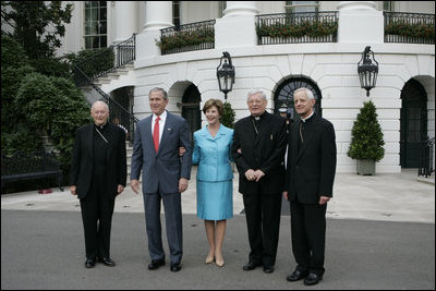 President George W. Bush and Laura Bush welcome outgoing Archbishop of Washington Theodore Cardinal McCarrick, left, the incoming Archbishop of Washington Donald W. Wuerl, right, and Papal Nuncio Pietro Sambi to the White House Tuesday evening, July 18, 2006, for a dinner in their honor.