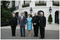 President George W. Bush and Laura Bush welcome outgoing Archbishop of Washington Theodore Cardinal McCarrick, left, the incoming Archbishop of Washington Donald W. Wuerl, right, and Papal Nuncio Pietro Sambi to the White House Tuesday evening, July 18, 2006, for a dinner in their honor.