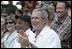 President George W. Bush and Laura Bush are joined by baseball legend and hall of famer Willie Mays, Tee Ball Commissioner for the day Sunday, July 30, 2006, at the Tee Ball on the South Lawn game between the Thurmont Little League Civitan Club of Frederick Challengers of Thurmont, Md., and the Shady Spring Little League Challenger Braves of Shady Spring, W. Va.