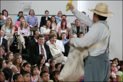 Mrs. Laura Bush watches Ricardo Araiza, one of the two actors, perform in the Childsplay production of Tomas and the Library Lady, at the Boys and Girls Club of the East Valley in Guadalupe, Arizona on June 16, 2006. The play promotes literacy and encourages young people to look past the confines of poverty, language barriers and cultural intolerance to find joy in reading.
