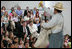 Mrs. Laura Bush watches Ricardo Araiza, one of the two actors, perform in the Childsplay production of Tomas and the Library Lady, at the Boys and Girls Club of the East Valley in Guadalupe, Arizona on June 16, 2006. The play promotes literacy and encourages young people to look past the confines of poverty, language barriers and cultural intolerance to find joy in reading.