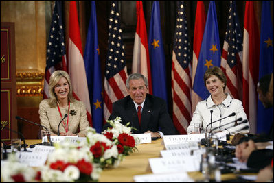President George W. Bush and Laura Bush are joined by U.S. Ambassador to Austria Susan McCaw during a roundtable discussion Wednesday, June 21, 2006, with foreign students at the National Library in Vienna.