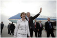 President George W. Bush waves as he and Laura Bush arrive at Budapest-Ferihegy Airport in Budapest Wednesday night, June 21, 2006, on the last leg of their journey to Europe.