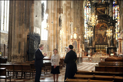 Mrs. Laura Bush admires the architecture of St. Stephen's Cathedral in Vienna, Austria, Wednesday, June 21, 2006, during a tour guided by Bernd Kolodziejczak, left, and Father Timothy McDonnell, right. The cathedral is of one of Vienna's most famous sights built in 1147 AD.