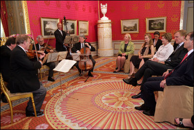 Mrs. Laura Bush listens to a concert by members of the Vienna Philharmonic at the Albertina Museum in Vienna, Austria, Wednesday, June 21, 2006, where she was also given a tour of the museum.