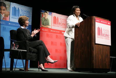 Mrs. Laura Bush applauds Caitlyn Clarke, high school Student of the Year for Jefferson Parish Public School System, Monday, June 26, 2006, as Miss Clarke speaks of her passion for reading before introducing Mrs. Bush during the 2006 American Library Association Conference in New Orleans, Louisiana.