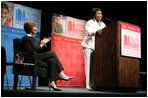Mrs. Laura Bush applauds Caitlyn Clarke, high school Student of the Year for Jefferson Parish Public School System, Monday, June 26, 2006, as Miss Clarke speaks of her passion for reading before introducing Mrs. Bush during the 2006 American Library Association Conference in New Orleans, Louisiana.