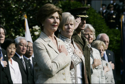 Mrs. Laura Bush stands with Lynne Pace and her husband, Chairman of the Joint Chiefs of Staff General Peter Pace, during the official arrival ceremony for Prime Minister Junichiro Koizumi of Japan on the South Lawn Thursday, June 29, 2006.