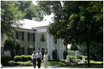 President George W. Bush, Laura Bush and Japanese Prime Minister Junichiro Koizumi, wearing a pair of Elvis-style sunglasses, tour the grounds of Graceland, the home of Elvis Presley, Friday, June 30, 2006, in Memphis.