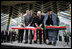 President George W. Bush and Afghanistan President Hamid Karzai, right, cut the ceremonial ribbon, Wednesday, March 1, 2006, to dedicate the new U.S. Embassy Building in Kabul, Afghanistan. President Bush is joined by Mrs. Laura Bush; U.S. Secretary of State Condoleezza Rice and U.S. Ambassador to Afghanistan Ronald E. Neumann.