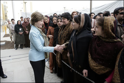 Mrs. Laura Bush greets a welcoming delegation of women, Wednesday, March 1, 2006, at the dedication of the new U.S. Embassy Building in Kabul, Afghanistan.