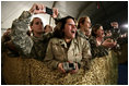 U.S. and Coalition troops cheer and take photos Wednesday, March 1, 2006, during an appearance by President George W. Bush and Mrs. Laura Bush at Bagram Air Base in Afghanistan.