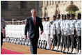 President George W. Bush reviews troops Thursday, March 2, 2006, during the arrival ceremony at Rashtrapati Bhavan, the presidential residence in New Delhi, welcoming he and Laura Bush to India.