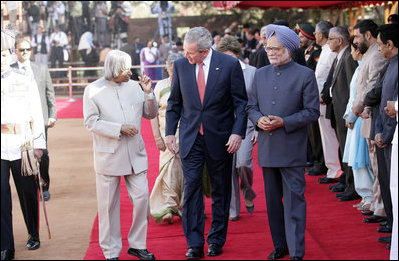 President George W. Bush listens to India's President A.P.J. Abdul Kalam as they walk the red carpet with Prime Minister Manmohan Singh during the arrival ceremony in New Delhi Thursday, March 2, 2006, welcoming the President and Mrs. Bush to India.