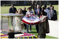 President George W. Bush and Laura Bush participate in a wreath-laying ceremony Thursday, March 2, 2006, in Rajghat, India, at the memorial for Mahatma Gandhi.